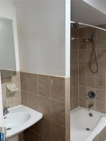 a bathroom with a sink a shower and a mirror