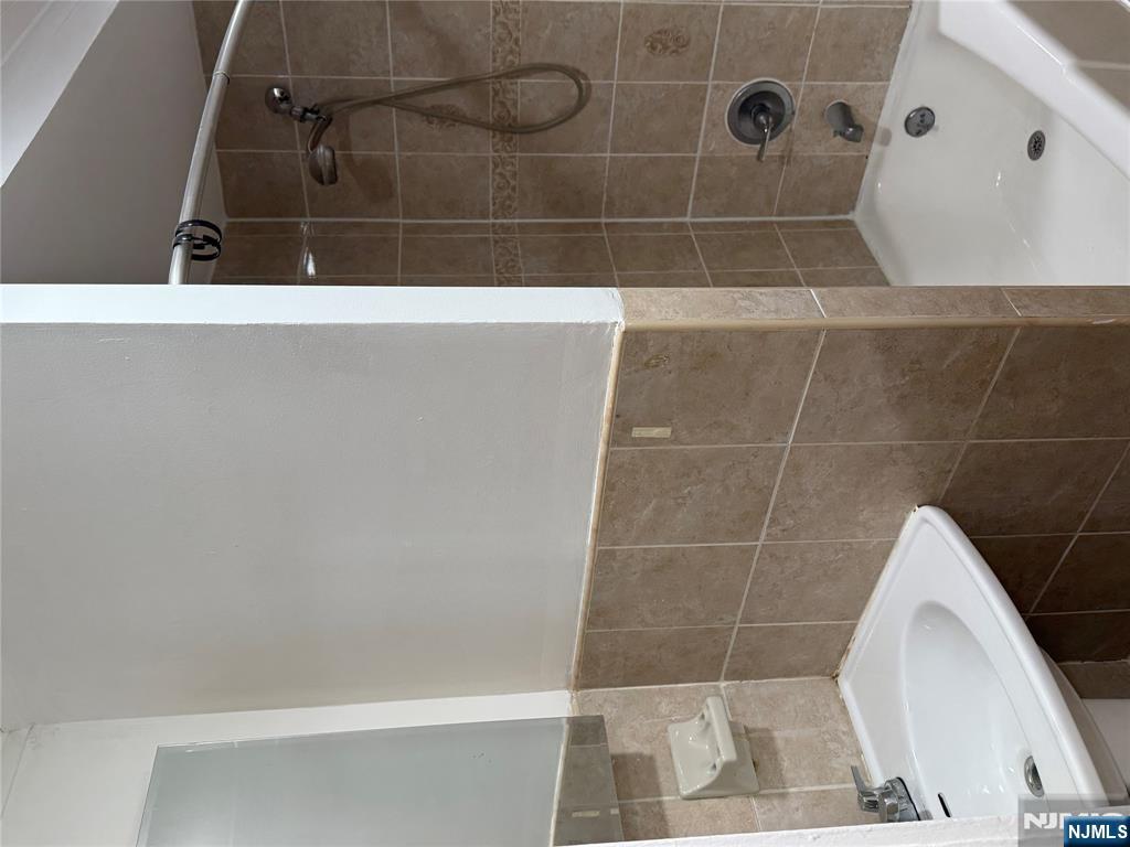 41 Wood Street, Unit 2 Rutherford, NJ 07070 - Photo 4 of 9 a bathroom with a sink a shower and a mirror