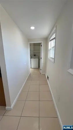a view of an empty room and a bathroom