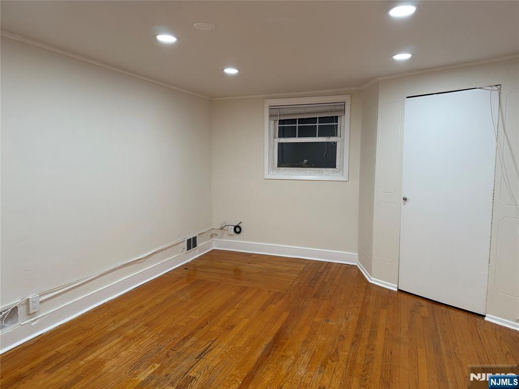 41 Wood Street, Unit 2 Rutherford, NJ 07070 - Photo 7 of 9 an empty room with wooden floor and windows