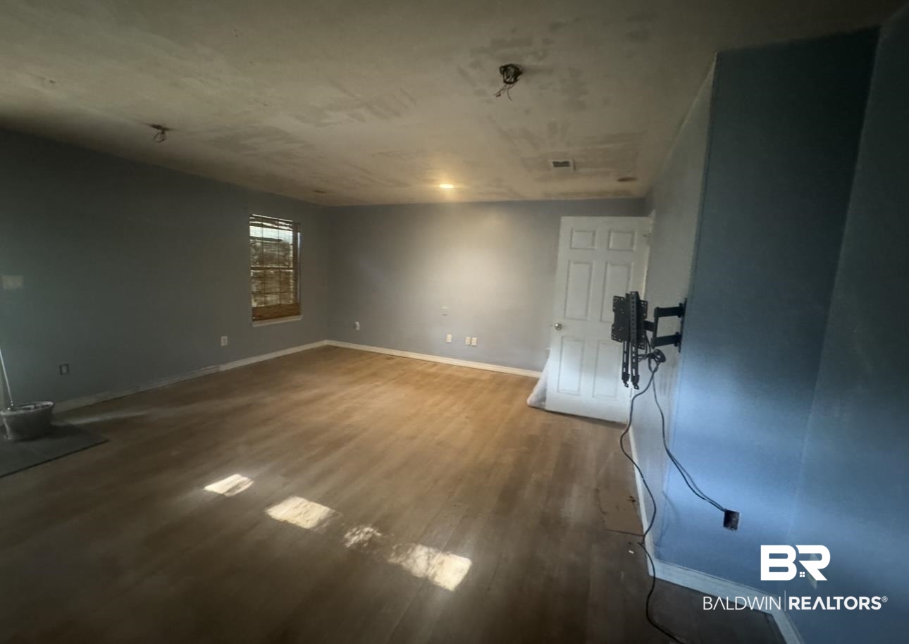 23341 County Road 49 Silverhill, AL 36576 - Photo 7 of 23 Unfurnished living room with baseboards and wood finished floors