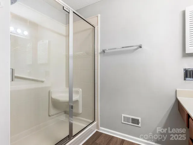 a bathroom with a glass shower door