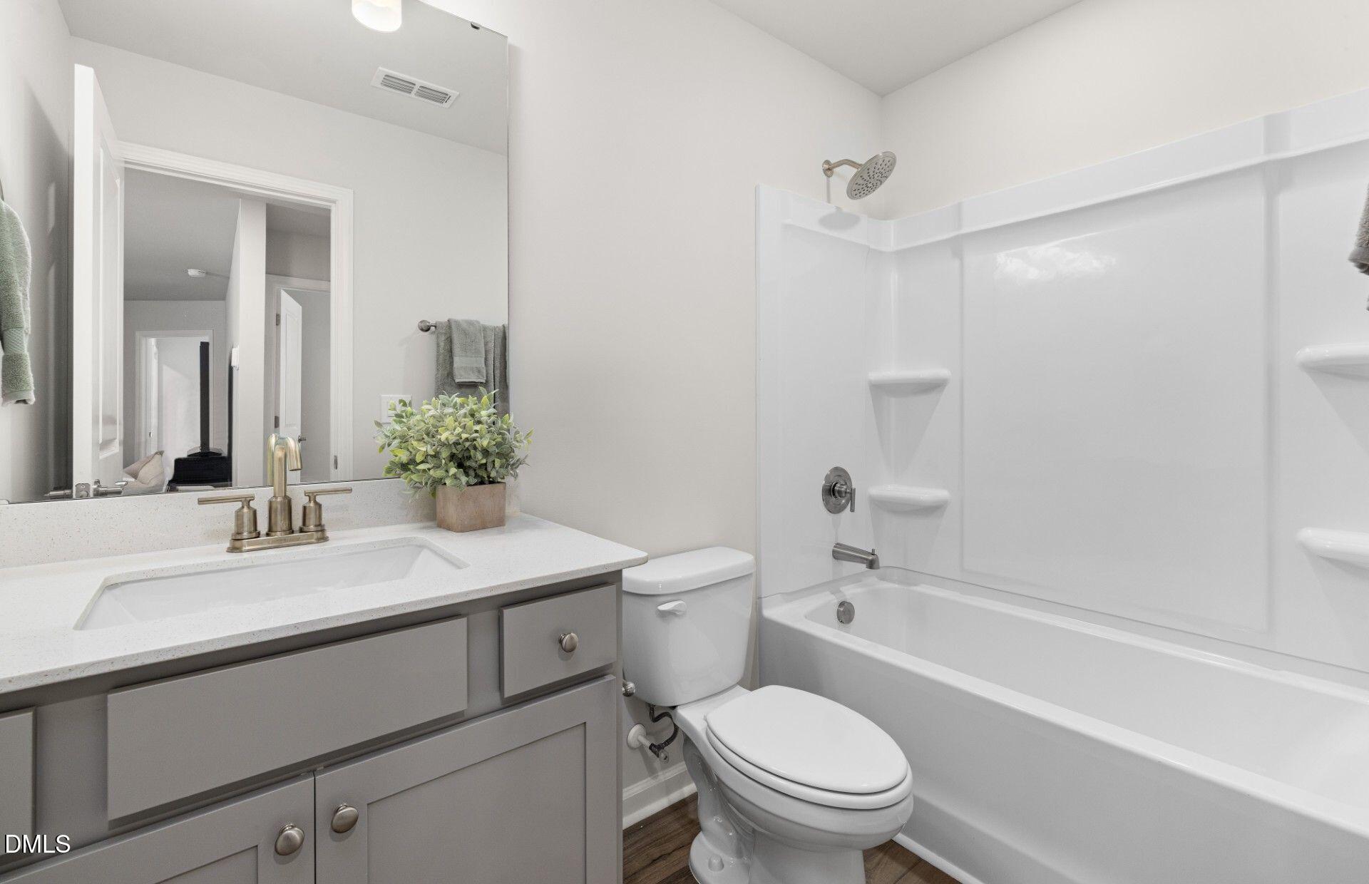 603 Timber Terrace Drive Durham, NC 27704 - Photo 11 of 17 a bathroom with a sink toilet vanity and shower