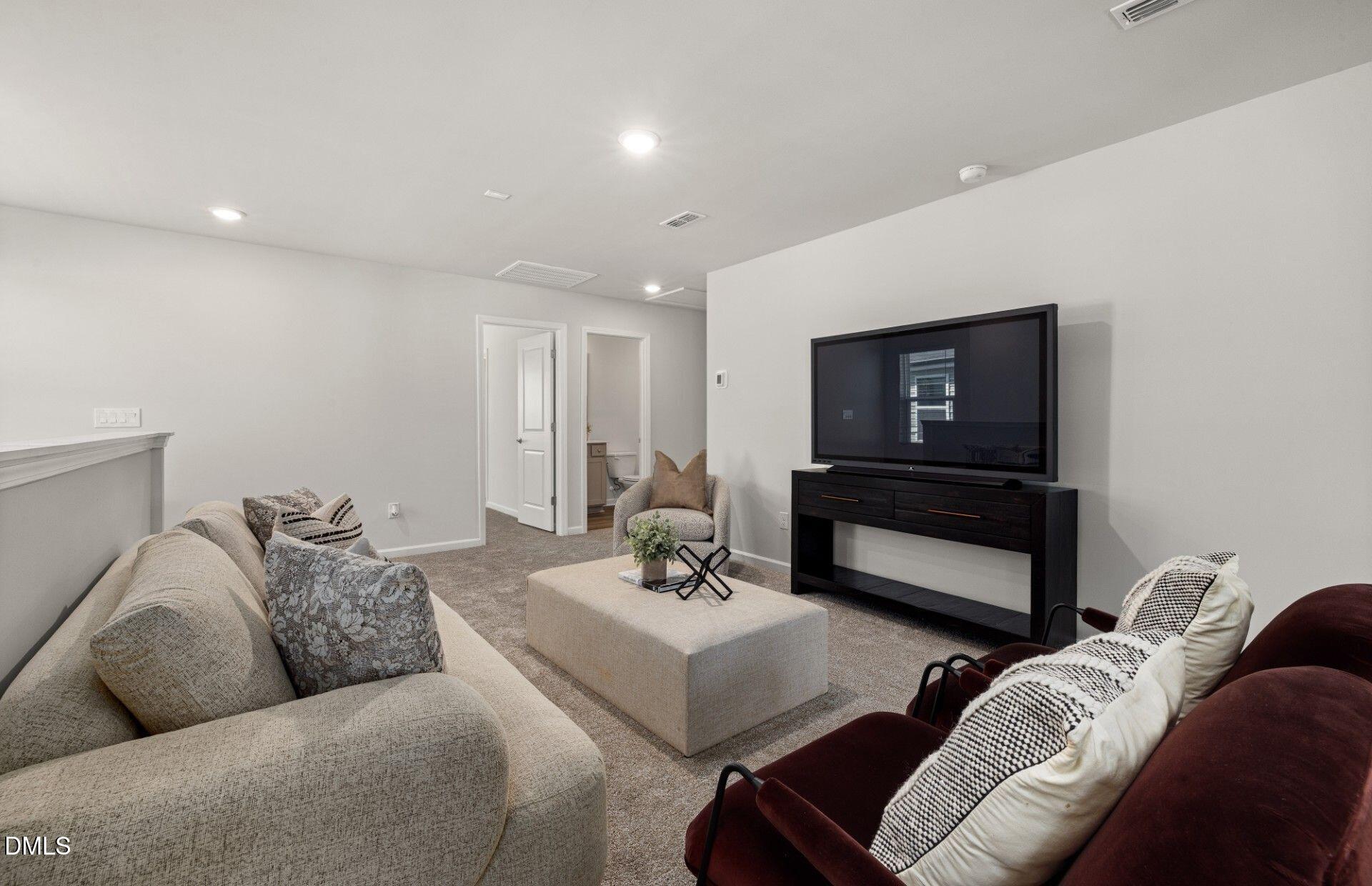 603 Timber Terrace Drive Durham, NC 27704 - Photo 13 of 17 a living room with furniture and a flat screen tv