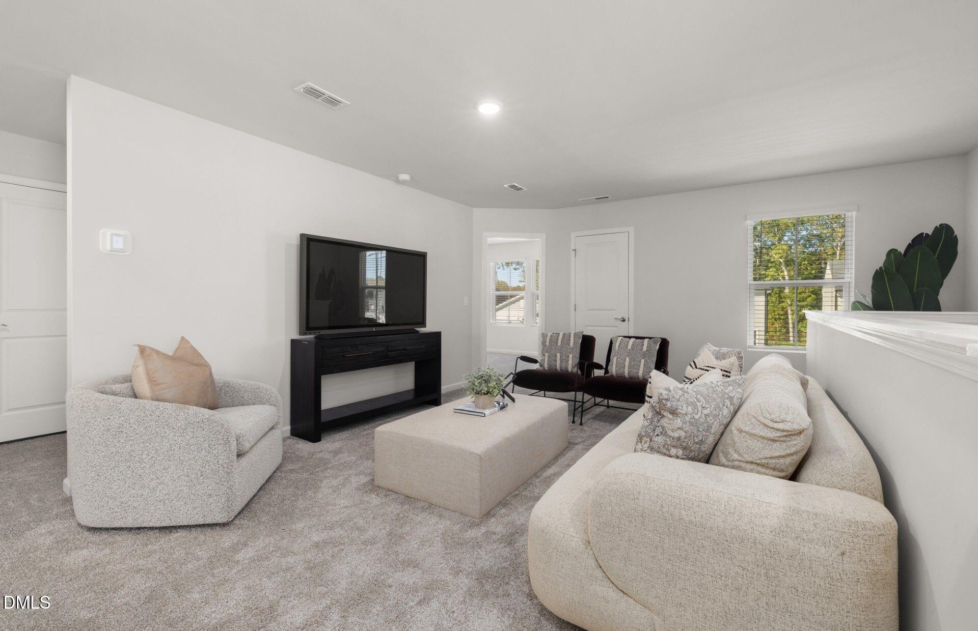 603 Timber Terrace Drive Durham, NC 27704 - Photo 14 of 17 a living room with furniture and a flat screen tv