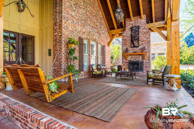 33509 Alder Circle Daphne, AL 36527 - Photo 2 of 28 A Front Porch that Boasts of a Fireplace, Room for Friends and Gorgeous Wood Beams.
