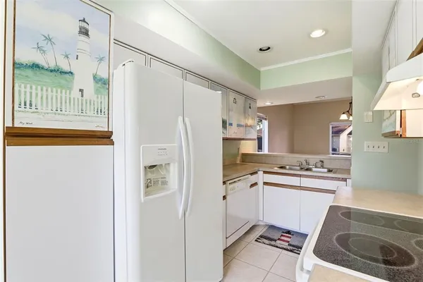 a kitchen with a sink a refrigerator a washer and dryer