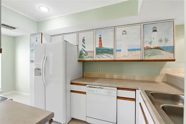 a sink and a refrigerator in a kitchen