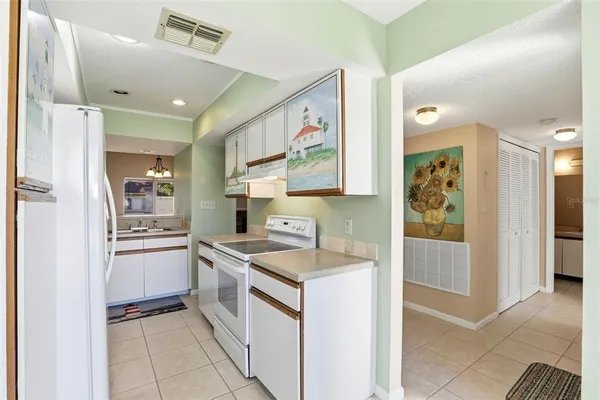 a kitchen with a stove and a refrigerator