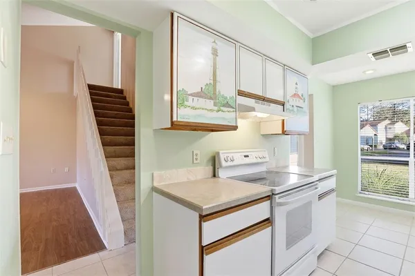 a kitchen that has a sink and a stove in it
