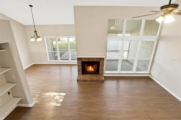 a view of empty room with wooden floor and fireplace