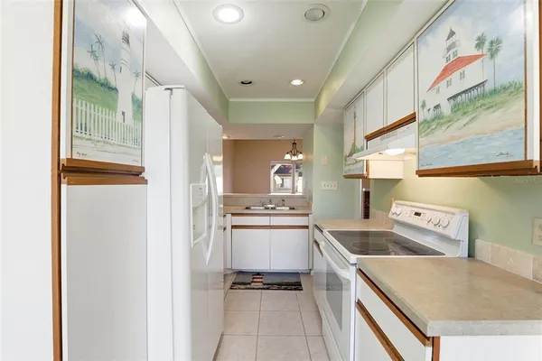 a kitchen with a stove a refrigerator and a sink