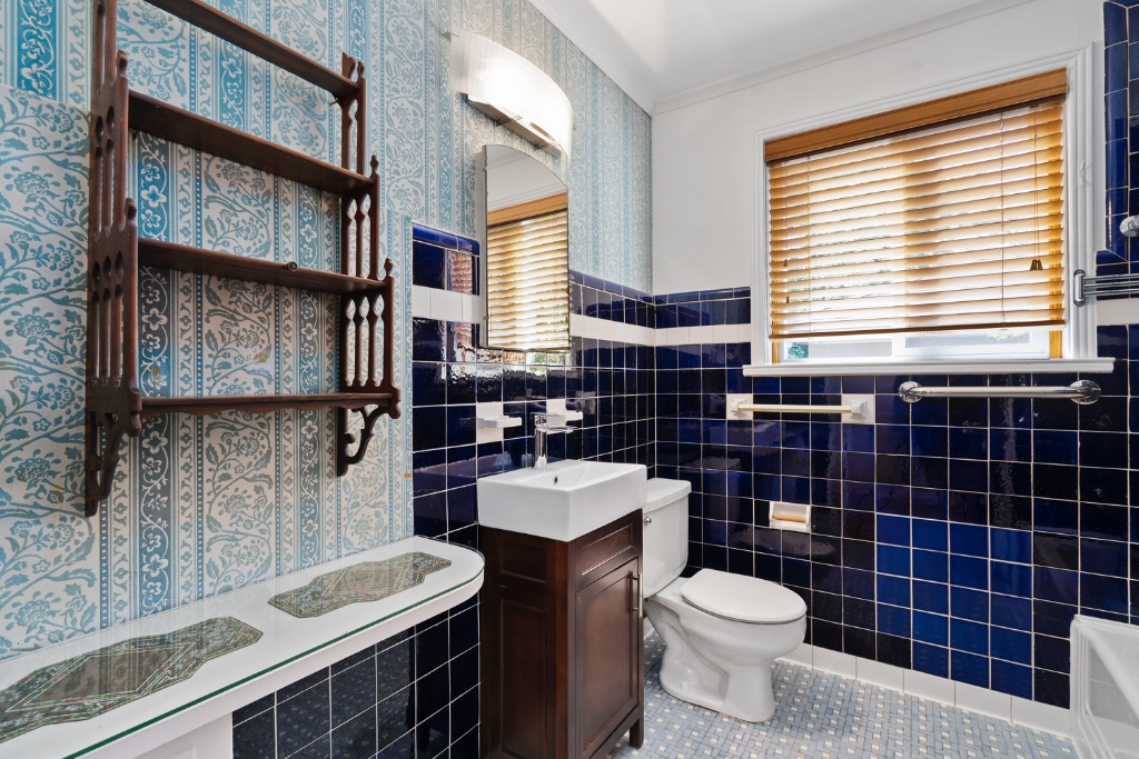 1212 Bentwood Road Austin, TX 78722 - Photo 17 of 32 a bathroom with a toilet sink and mirror