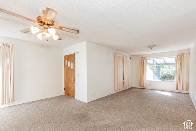 3959 Main Street Logan, UT 84321 - Photo 17 of 35 Recessed ceiling light, ceiling fan with integrated lighting, wood-paneled door, large window, and carpeted flooring
