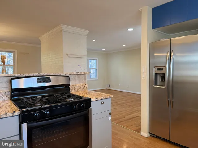 a stove top oven sitting inside of a kitchen
