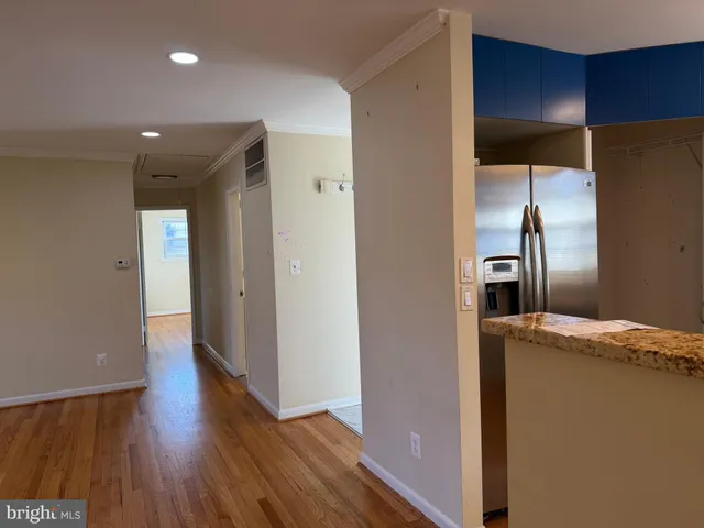 a view of a refrigerator in kitchen and wooden floor