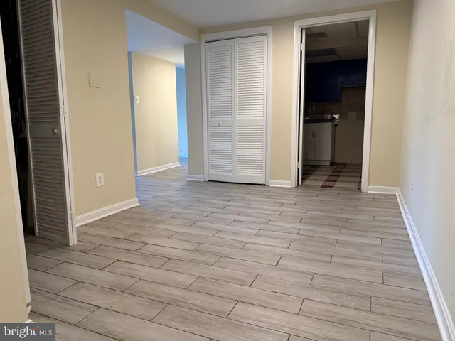 an empty room with wooden floor and closet