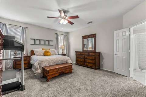 a spacious bedroom with a bed and a chandelier