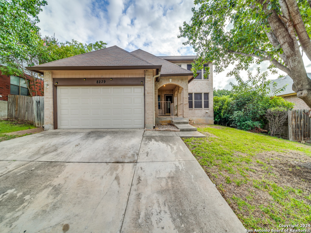 a front view of a house with yard