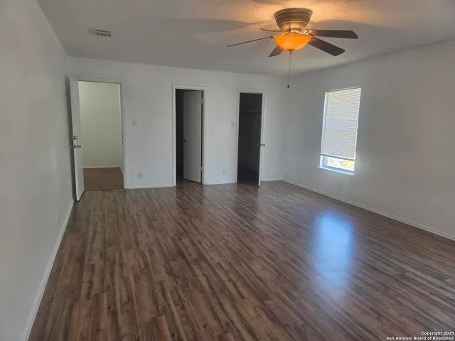 a bathroom with a granite countertop sink a mirror and a shower