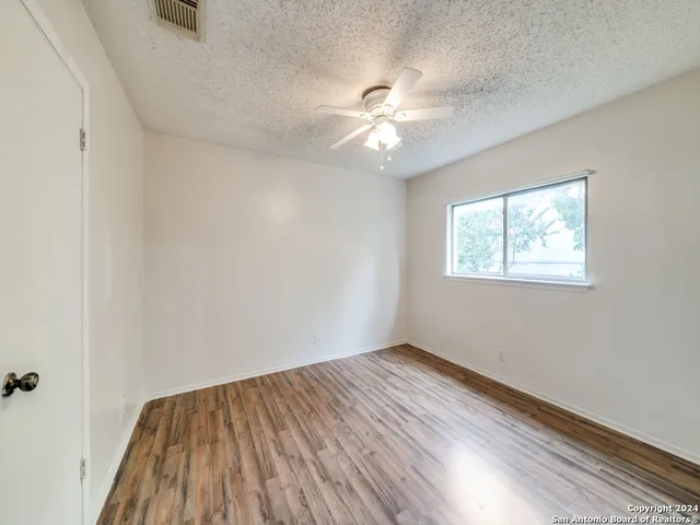 a bathroom with a toilet a sink a mirror a bathtub and vanity