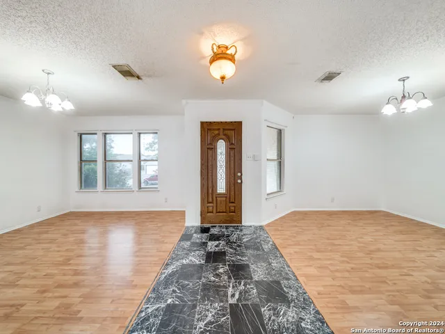 a view of an entryway with wooden floor