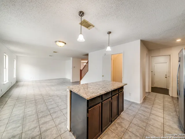 a view of a livingroom with furniture and a kitchen