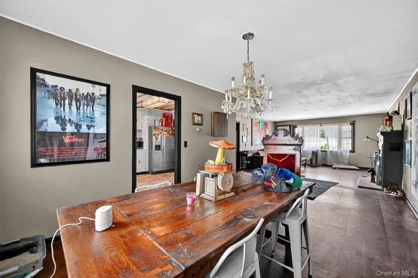 a view of a dining room with furniture a chandelier and wooden floor