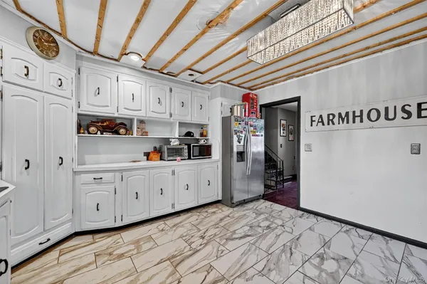 a kitchen with stainless steel appliances granite countertop a refrigerator and cabinets