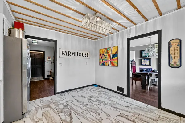 a view of a hallway with wooden floor and furniture