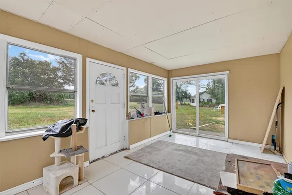 a living room with hardwood floor and balcony