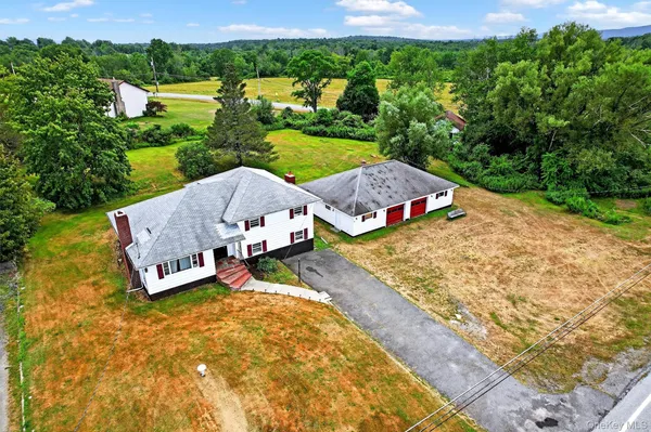 an aerial view of a house with garden space and street view