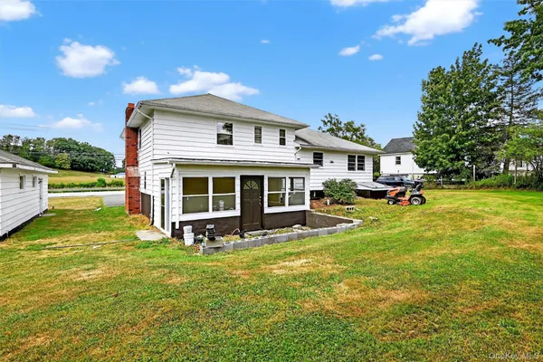 a front view of a house with a yard table and chairs
