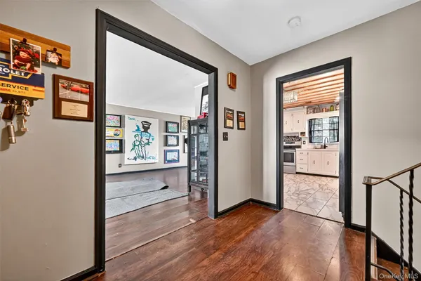 a view of a hallway with wooden floor and dining room
