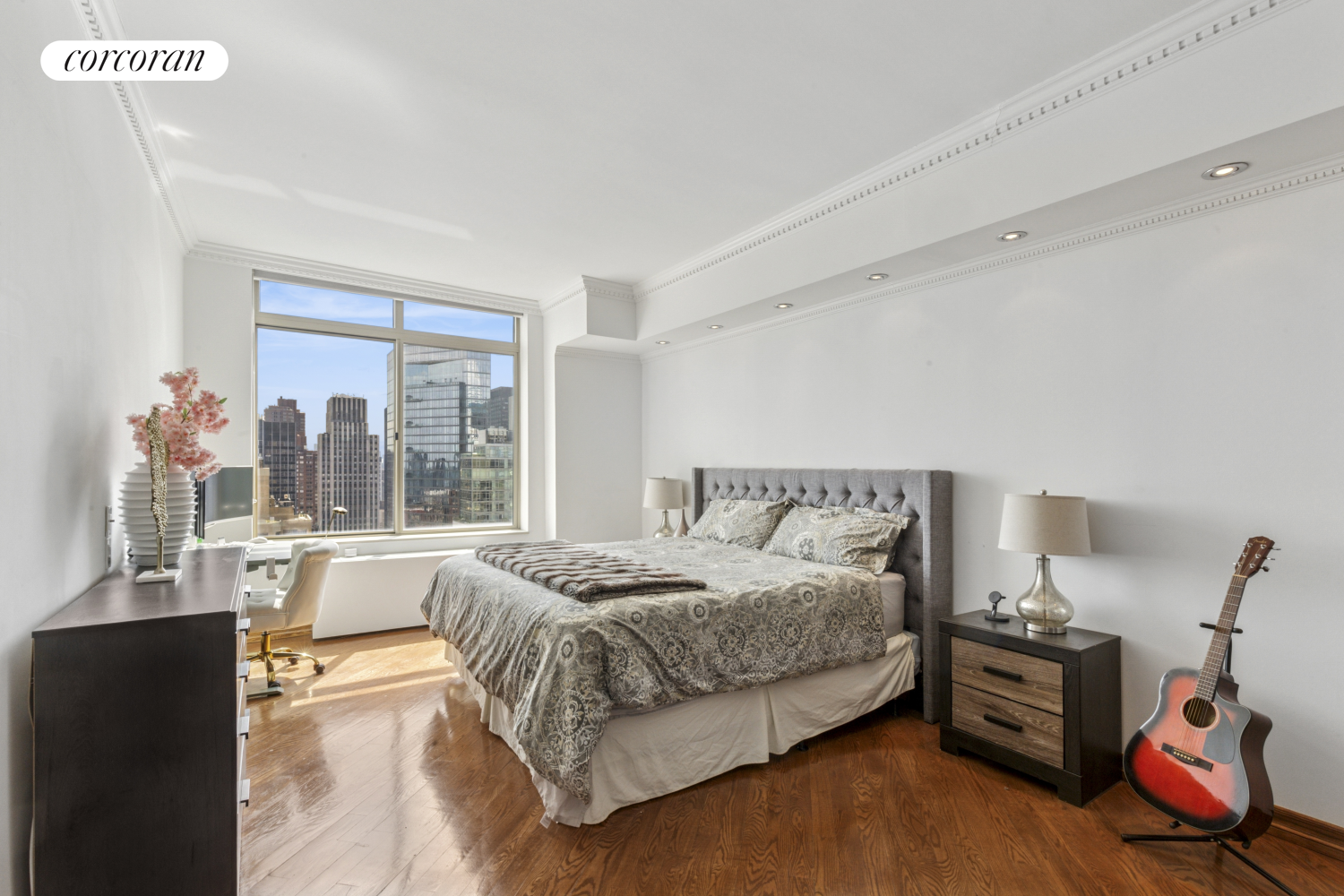 236 East 47th Street, Unit PH1A Manhattan, NY 10017 - Photo 3 of 9 a bedroom with a bed and wooden floor