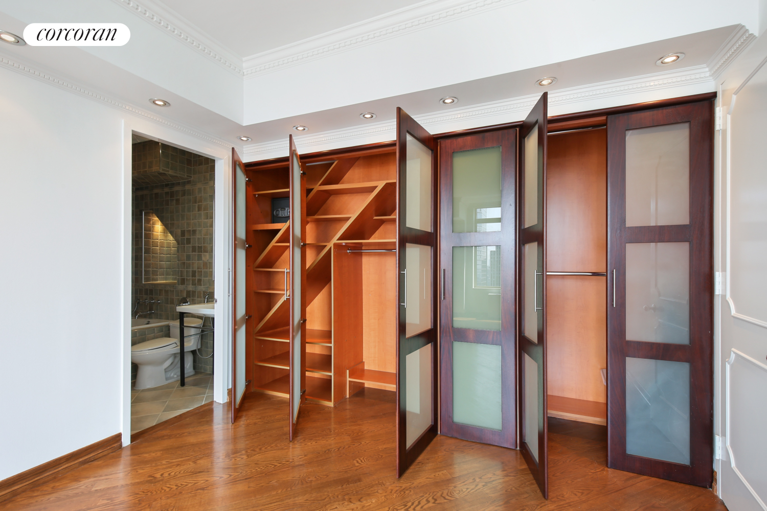 236 East 47th Street, Unit PH1A Manhattan, NY 10017 - Photo 5 of 9 a view of an empty room with wooden floor and a window
