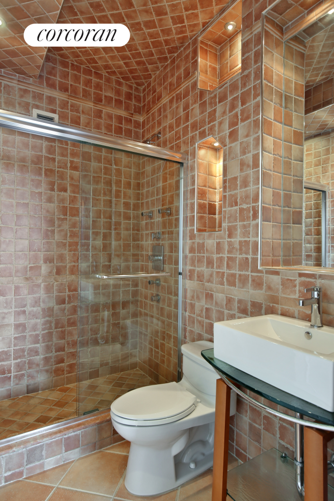 236 East 47th Street, Unit PH1A Manhattan, NY 10017 - Photo 7 of 9 a bathroom with a sink a toilet and shower