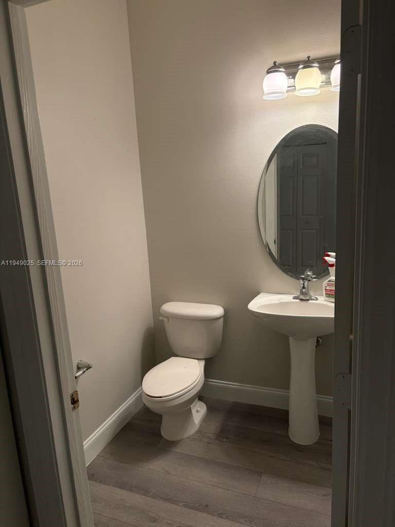 2511 Southwest 99th Way, Unit 2511 Miramar, FL 33025 - Photo 11 of 23 a bathroom with a sink toilet and a mirror
