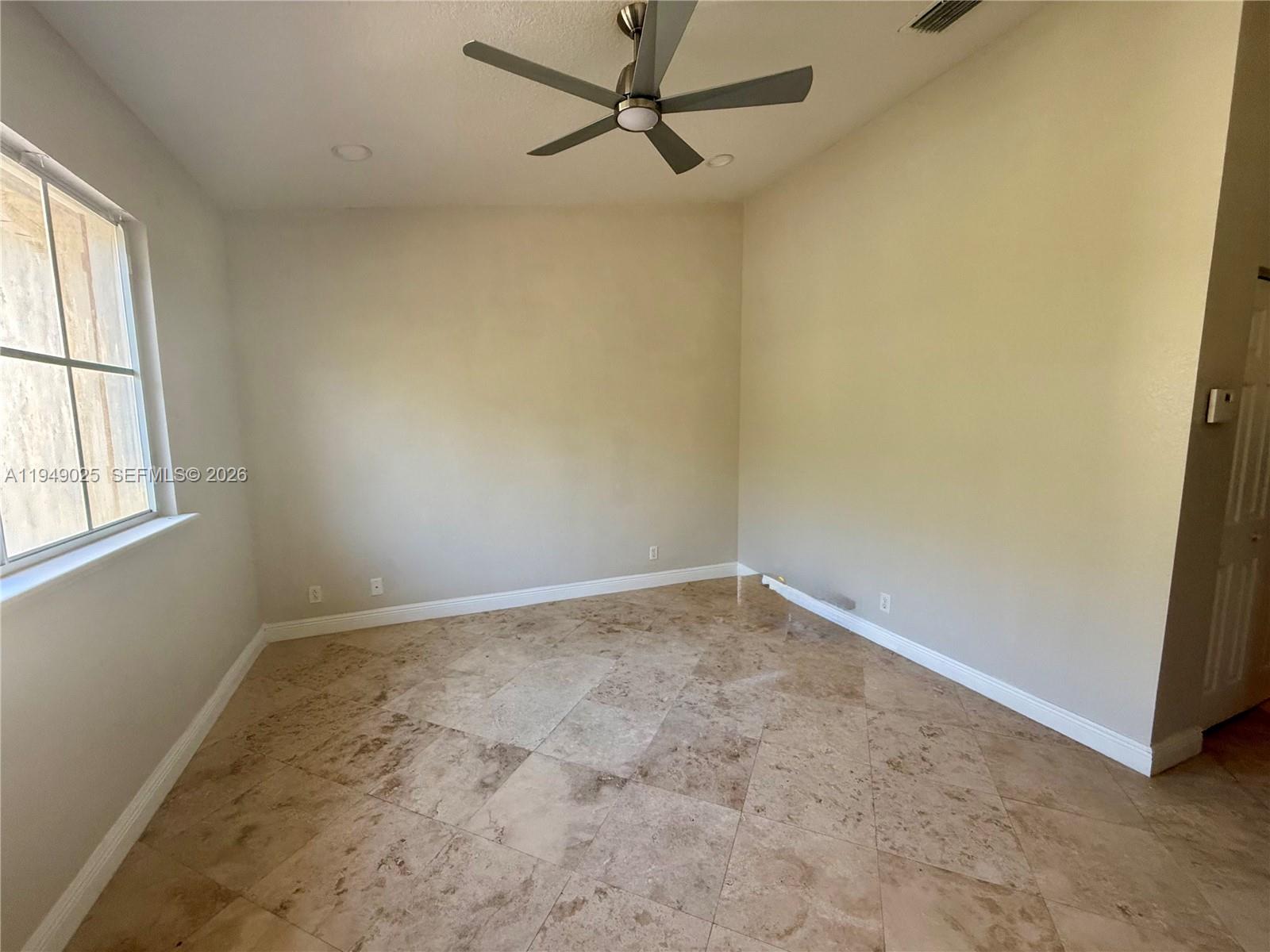 2511 Southwest 99th Way, Unit 2511 Miramar, FL 33025 - Photo 12 of 23 an empty room with a window and a fan