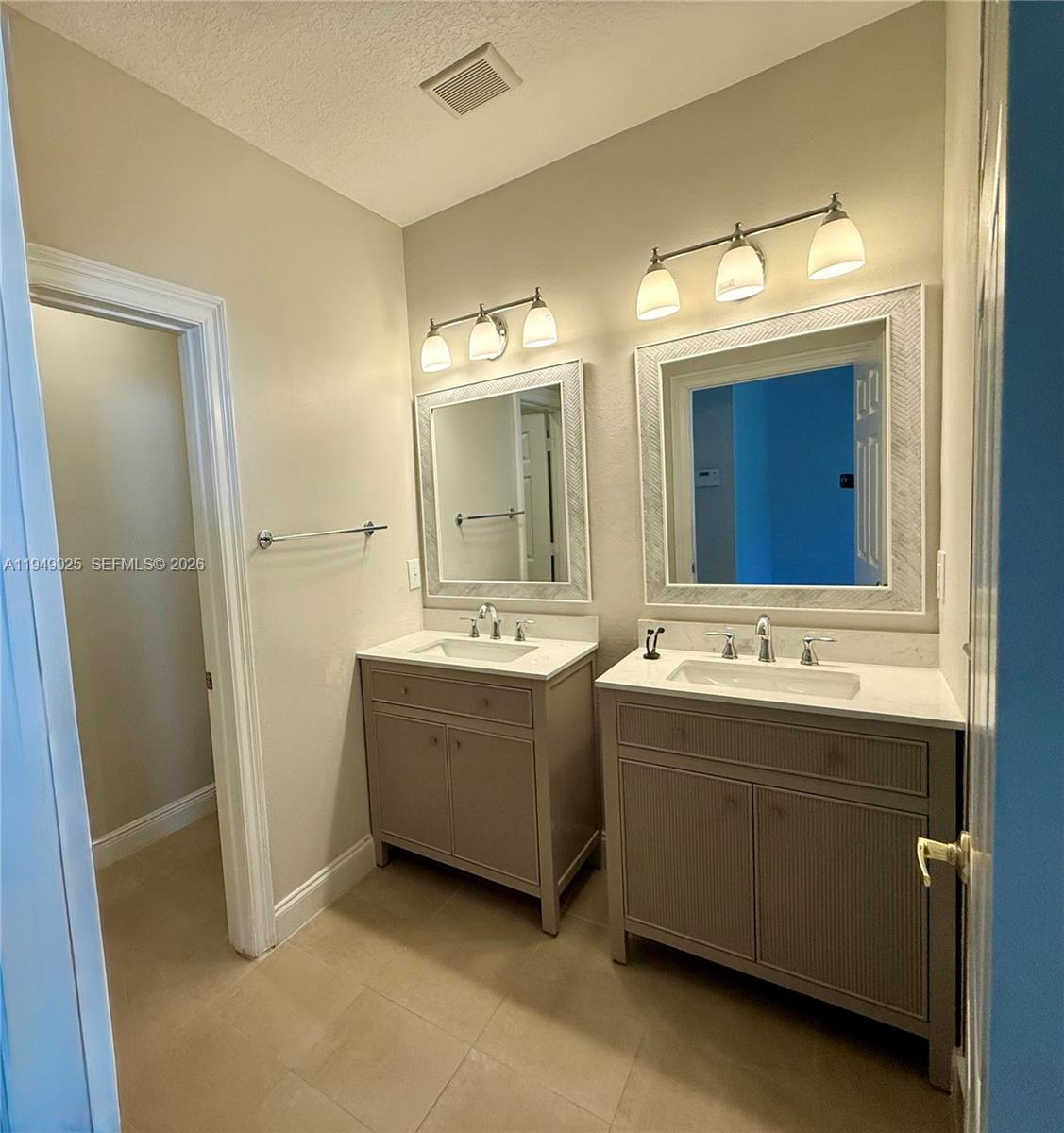 2511 Southwest 99th Way, Unit 2511 Miramar, FL 33025 - Photo 13 of 23 a bathroom with a double vanity sink mirror and a bathtub