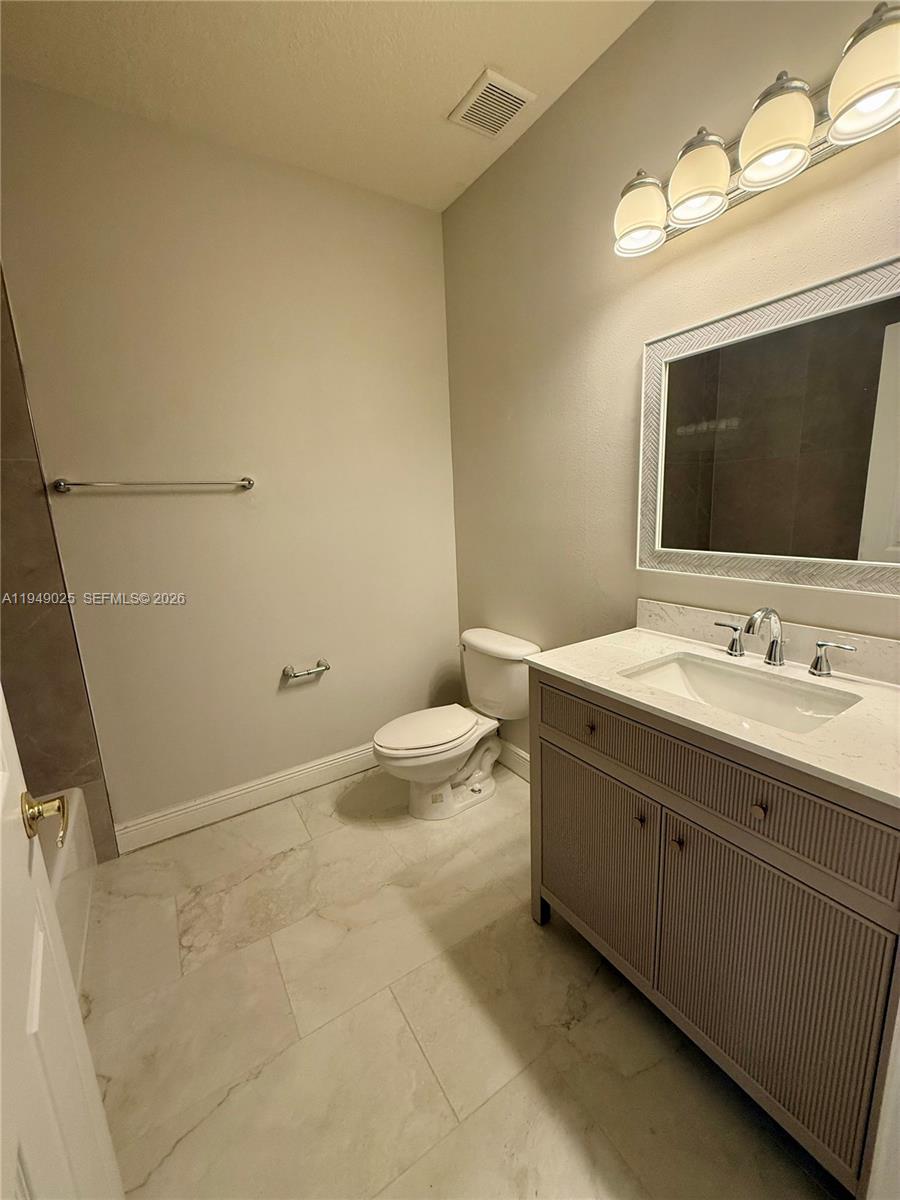 2511 Southwest 99th Way, Unit 2511 Miramar, FL 33025 - Photo 17 of 23 a spacious bathroom with a double vanity sink toilet and mirror