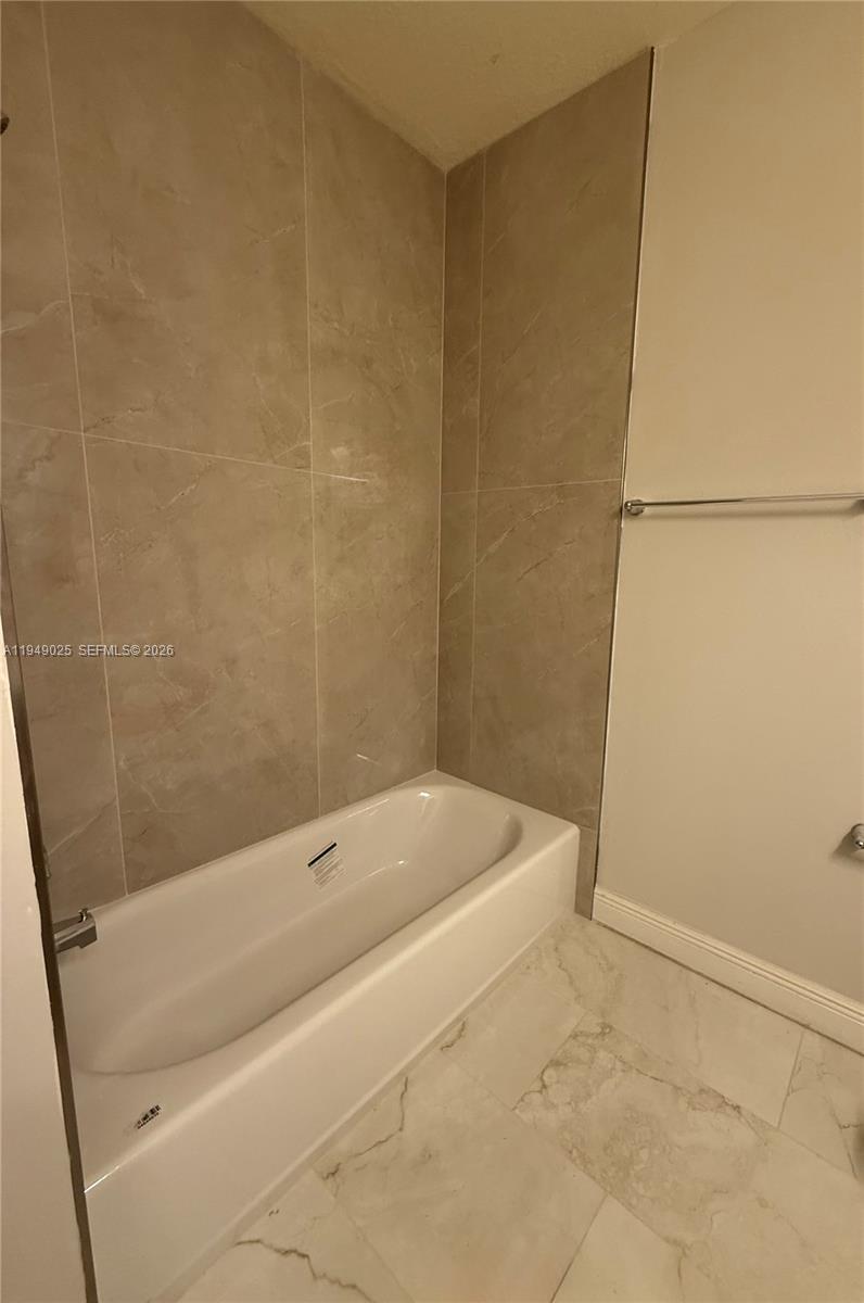 2511 Southwest 99th Way, Unit 2511 Miramar, FL 33025 - Photo 18 of 23 a bathroom with a bathtub