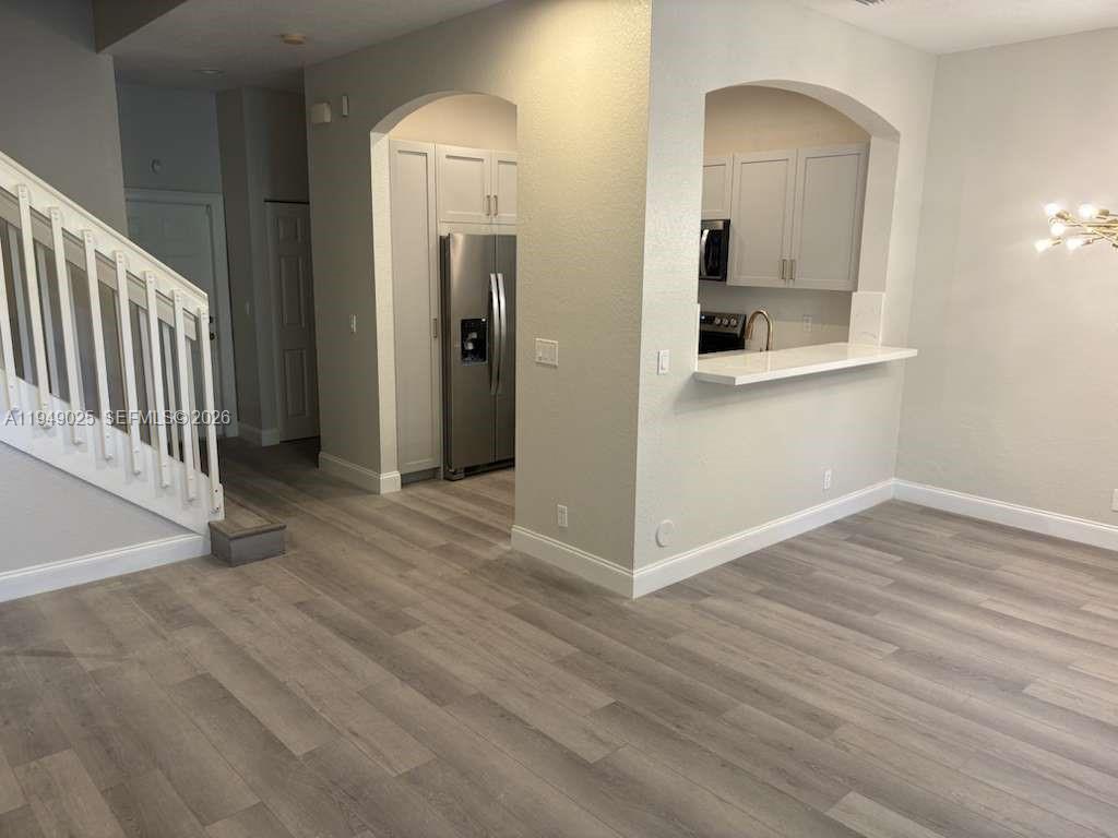2511 Southwest 99th Way, Unit 2511 Miramar, FL 33025 - Photo 7 of 23 a view of a hallway with wooden floor and a bathroom