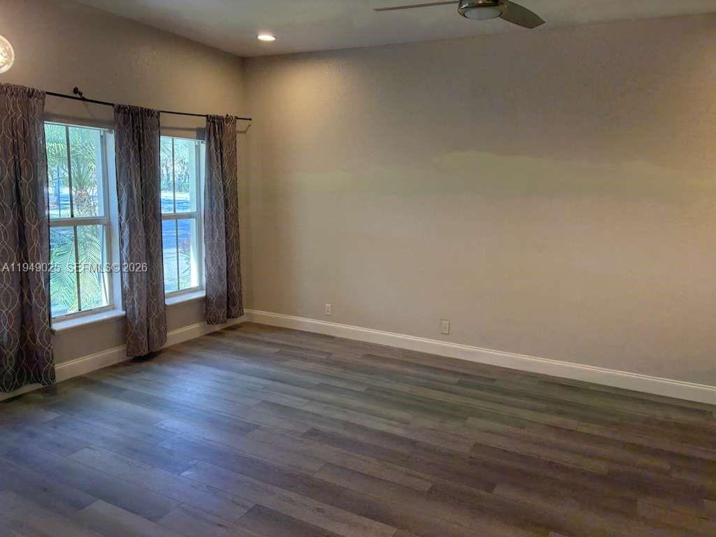 2511 Southwest 99th Way, Unit 2511 Miramar, FL 33025 - Photo 8 of 23 an empty room with wooden floor and windows