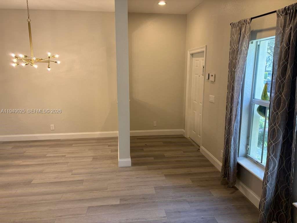 2511 Southwest 99th Way, Unit 2511 Miramar, FL 33025 - Photo 9 of 23 a view of a room with wooden floor and staircase