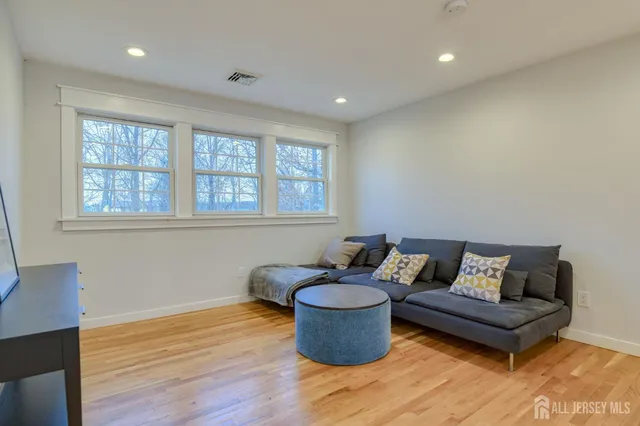 a bedroom with a large bed and a wooden floor