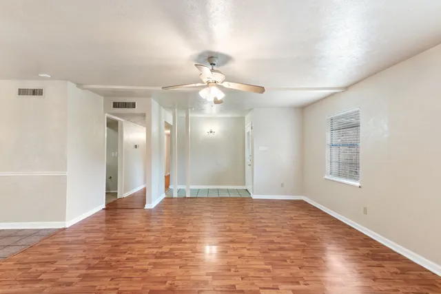 wooden floor in an empty room with a window