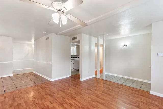 a view of empty room with wooden floor