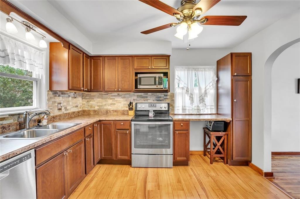 1726 Chester Road Verona, PA 15147 - Photo 8 of 25 a kitchen with stainless steel appliances granite countertop a stove cabinets and a sink
