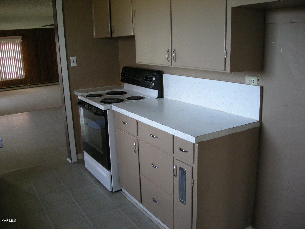 5312 Gamache Road Moxee, WA 98936 - Photo 7 of 15 a kitchen with white cabinets and white appliances